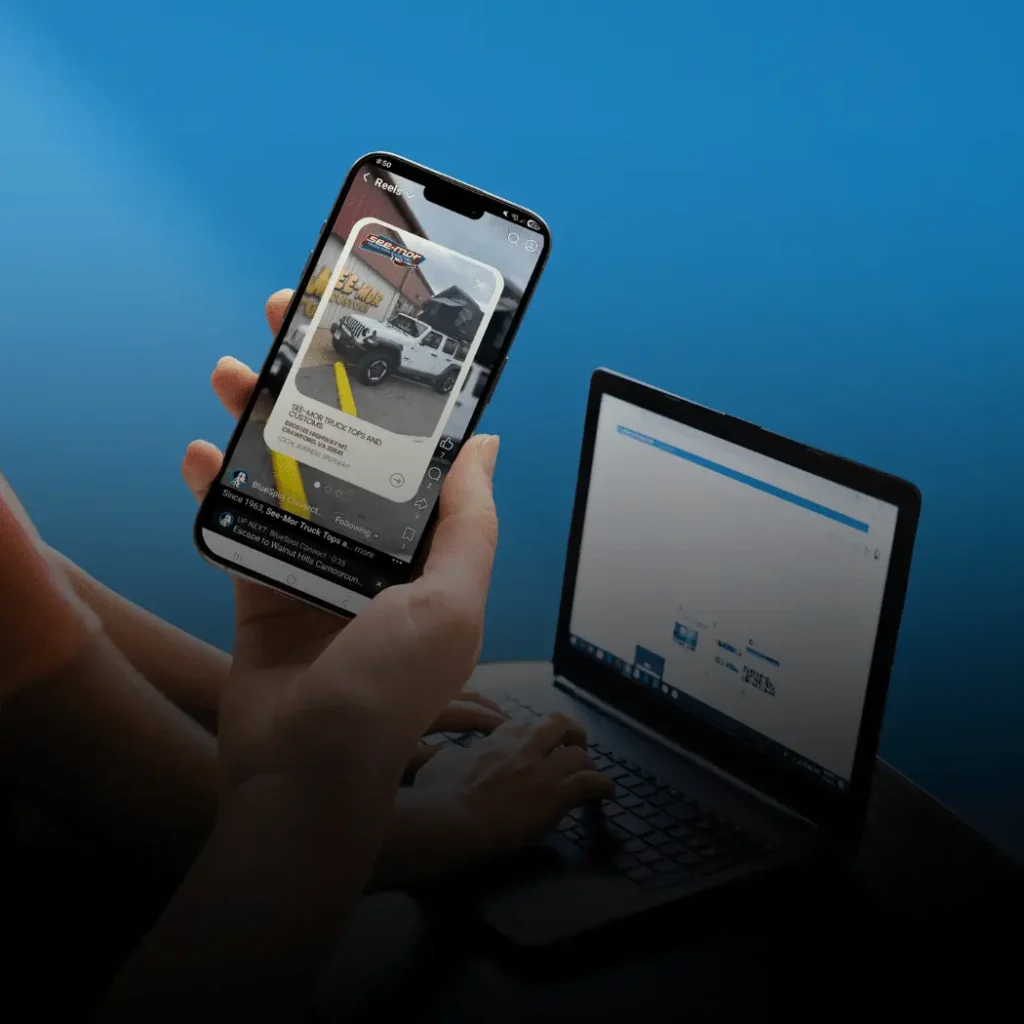 Smartphone displaying a social media advertisement beside a laptop, illustrating campground digital ads.