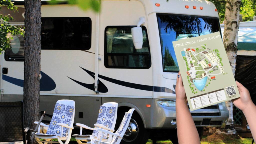 Camper holding a campground map near RV site