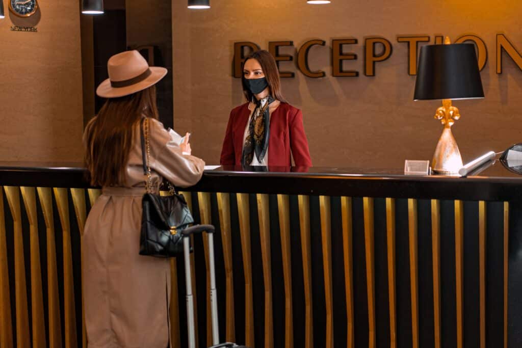 Hotel guest checking in at the front desk during the hotel check-in process